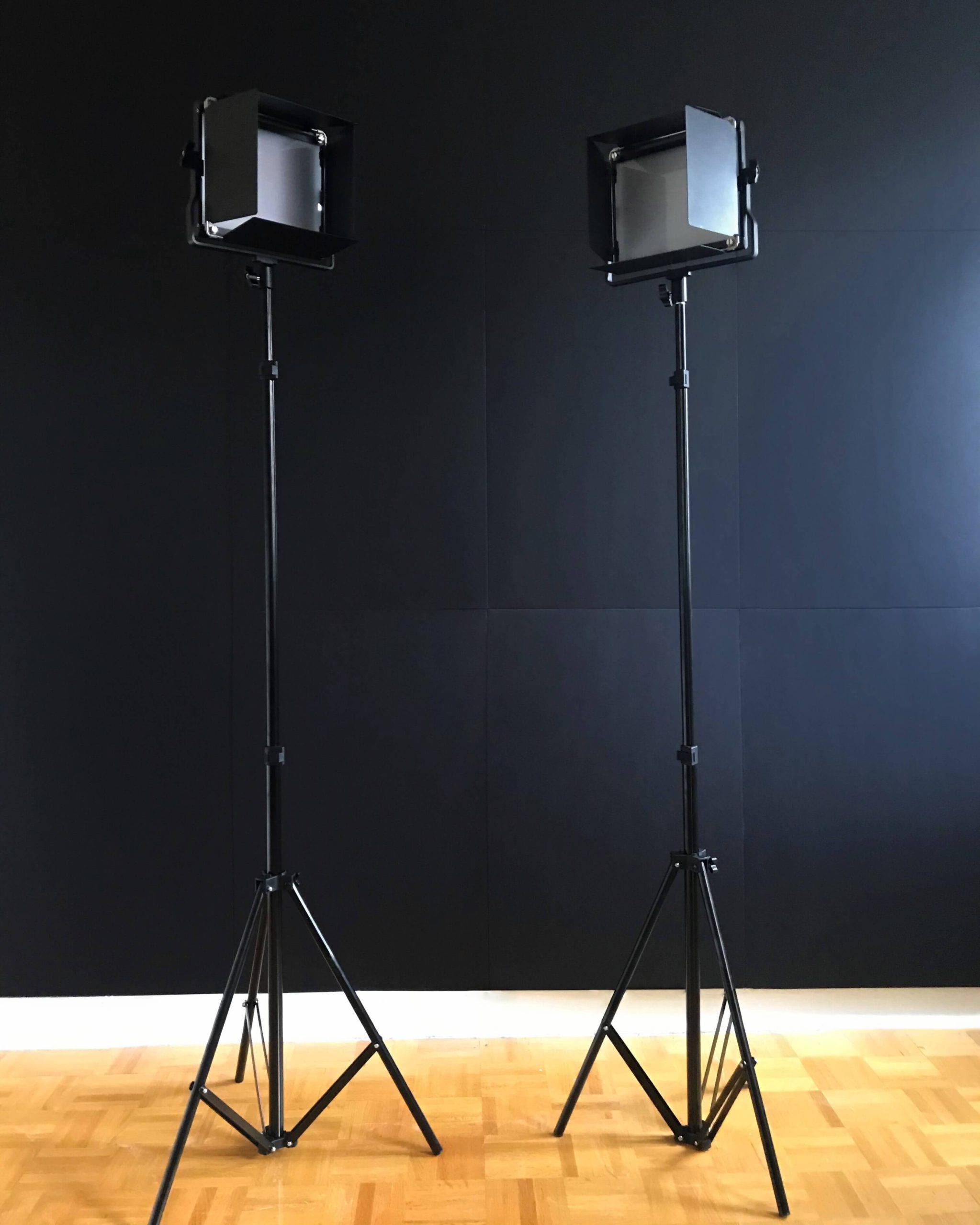 Lightboard presenter lights in front of the black backdrop panels